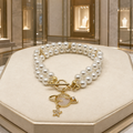 Bracelet double rang en perles de coquillage et papillons plaqué or
