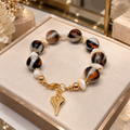 Bracelet femme en bakélite marbrée et nacre baroque – Cœur doré -18 cm
